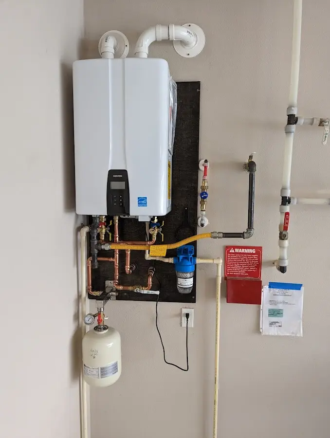 Professional plumber installing copper piping in a East Liverpool home